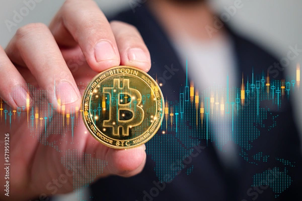 Fototapeta gold bitcoin is holding by businessman, symbol of cryptocurrency investment and speculation for more income and wealth of investor