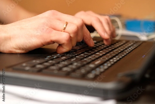Fototapeta Image of man's hands typing. Selective focus