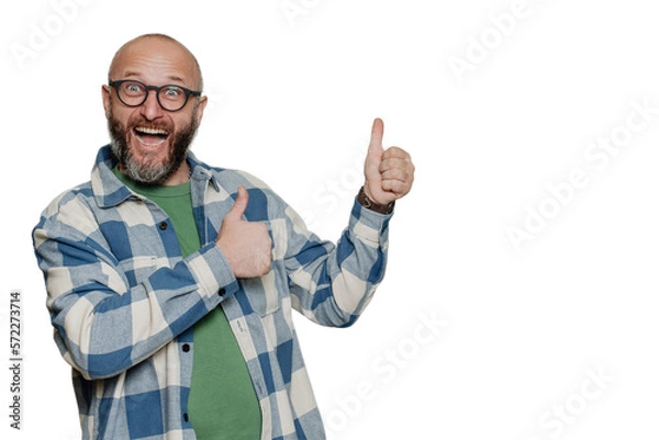 Fototapeta Excited mid adult Caucasian bald beardy man in spectacles, plaid shirt screams with wide opened mouth and eyes gestures thumb up  points at empty space over transparent background. Mockup, sale.