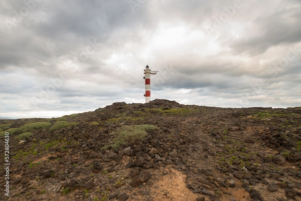 Obraz Desert landscape with volcanic rocks, lighthouse and storm clouds. Aabdes, Tenerife, Canary Islands. Spain