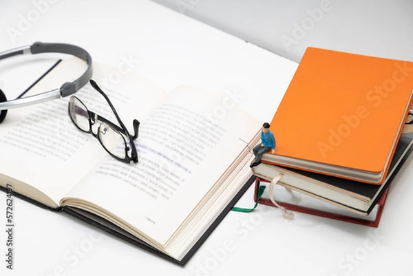 Obraz Open book and naked man's glasses