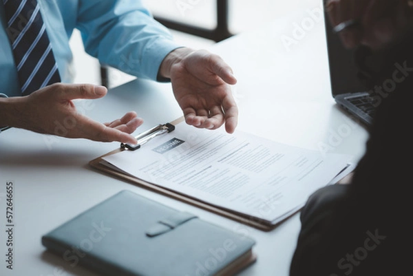 Fototapeta A person attends a job interview with a manager to join a company, he holds a resume and interview with information introducing himself and his ability to work. Job application concept.