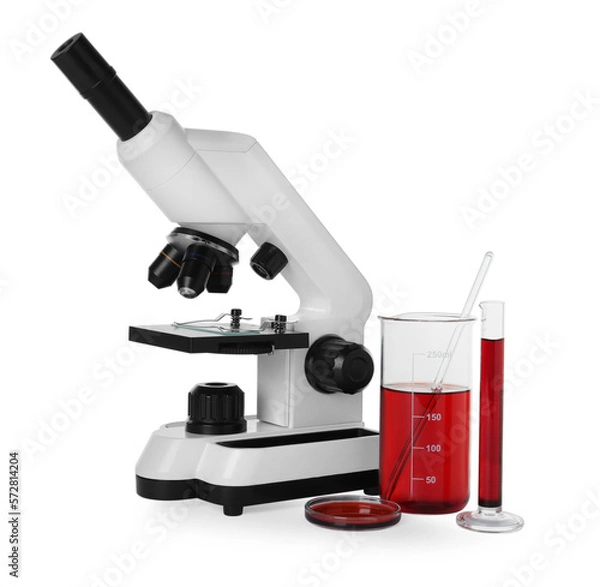 Fototapeta Laboratory glassware with red liquid and microscope isolated on white