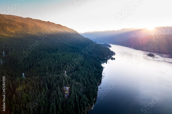 Fototapeta Aerial drone photo of sunrise over mountains and ocean shot of Quarry Rock with hikers on-top in Deep Cove, North Vancouver.