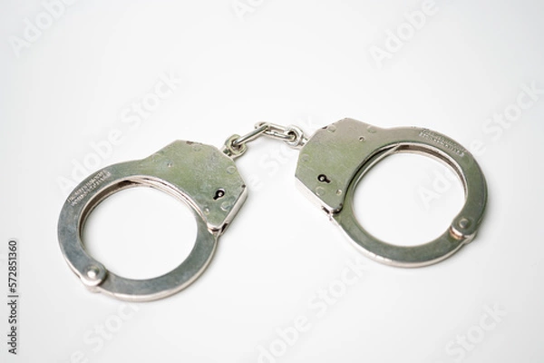 Obraz Object is a unilateral handcuff made of iron, single lock, on a white background, symbolizing the law and the offense.