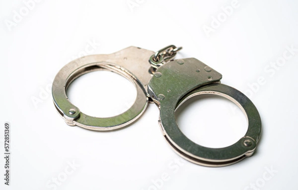 Obraz Object is a unilateral handcuff made of iron, single lock, on a white background, symbolizing the law and the offense.