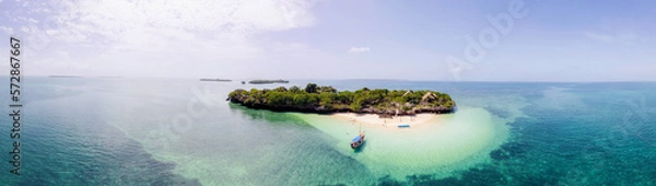 Fototapeta Experience Zanzibar's Blue Safari on a traditional wooden dhow boat. Dive into coral reefs, explore deserted islands in the middle of the ocean