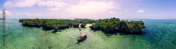 Fototapeta Off-the-Beaten-Path Adventure in Zanzibar: Join a Blue Safari aboard a Dhow Boat!