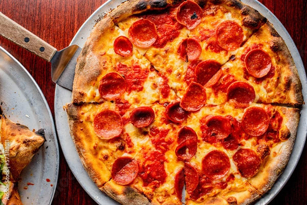 Fototapeta Pizza. Cheese Pizza. Traditional New York City style margarita pizza pie with a thin homemade crispy crust, tomato, garlic, marinara sauce topped with buffalo mozzarella cheese and fresh basil leaves.