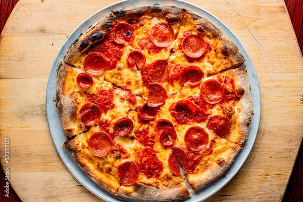 Fototapeta Pizza. Cheese Pizza. Traditional New York City style margarita pizza pie with a thin homemade crispy crust, tomato, garlic, marinara sauce topped with buffalo mozzarella cheese and fresh basil leaves.