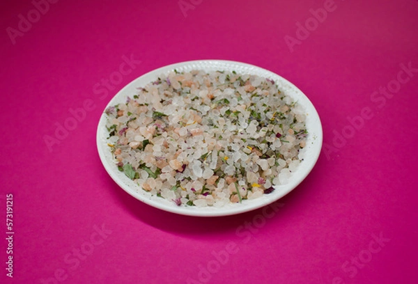 Obraz herbal salt on a white plate on a pink background