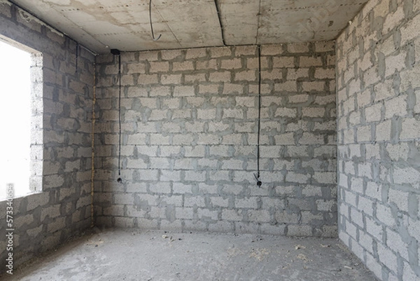 Fototapeta Construction of an individual residential building, a view of the expanded clay concrete wall without finishing, electric wires are laid