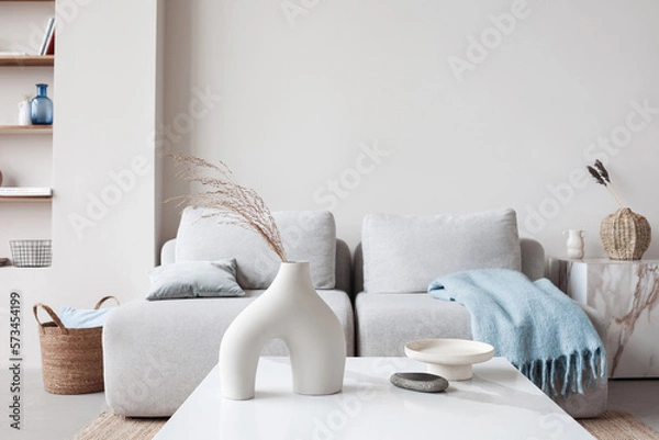 Fototapeta View of modern scandinavian style interior with sofa and trendy vase, Home staging and minimalism concept