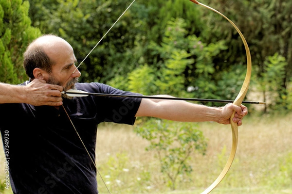 Obraz man shooting with bow