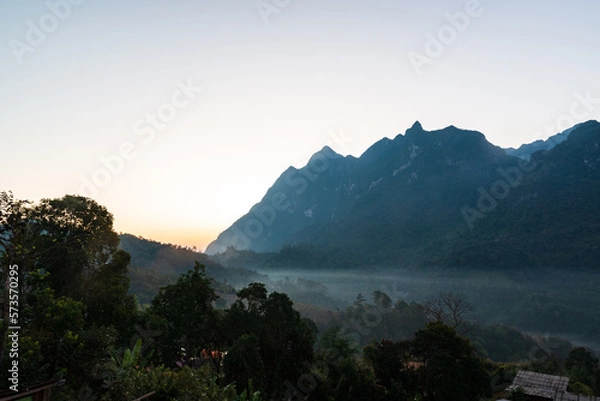 Fototapeta Panoramic view of Doi Luang Chiang Dao, (Doi Chiang Dao) is the third highest peak mountain in Thailand while morning mist flows through the valley area, Chiang Dao District, Chiang Mai, Thailand.