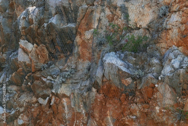 Fototapeta A safety net covering cliffs. Protection against falling rocks.