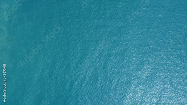 Fototapeta Blue water texture. Top view of the ocean surface with waves