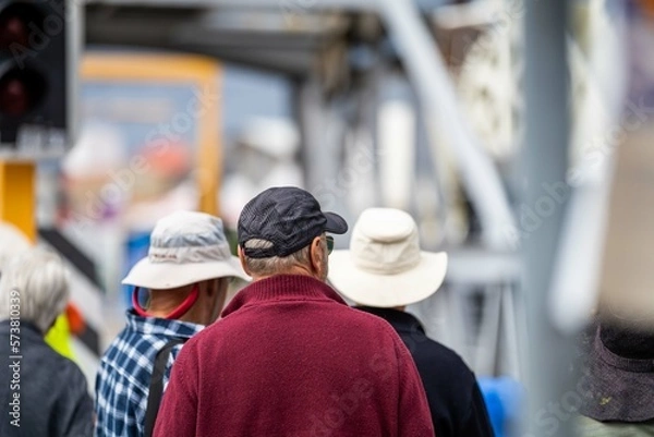 Fototapeta crowd of old people watching an event of boats outside in summer in australia