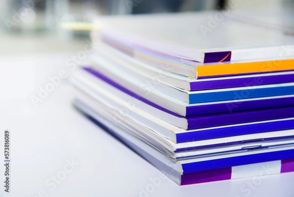 Fototapeta Stack of books on the desk in office. Selective focus.