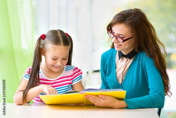 Obraz Mother is reading book with her daughter