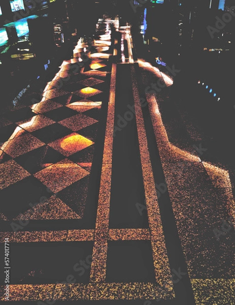 Fototapeta Corridor of a mall, where reflections and lights transform the environment into a futuristic and intriguing environment.
