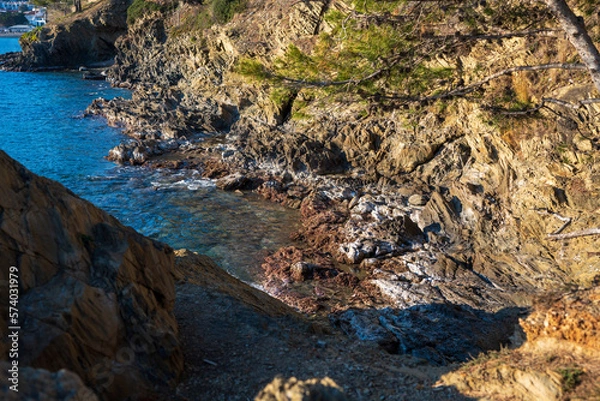 Fototapeta Cap de Creus Alt Emporda, Spain. February 2023 Rugged rocky coastline with turquoise waters in contrast. Sharp rocks extend out to the sea, creating a dramatic and wild texture.