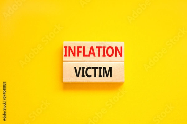 Fototapeta Inflation victim symbol. Concept words Inflation victim on wooden block. Beautiful yellow table yellow background. Business inflation victim concept. Copy space.