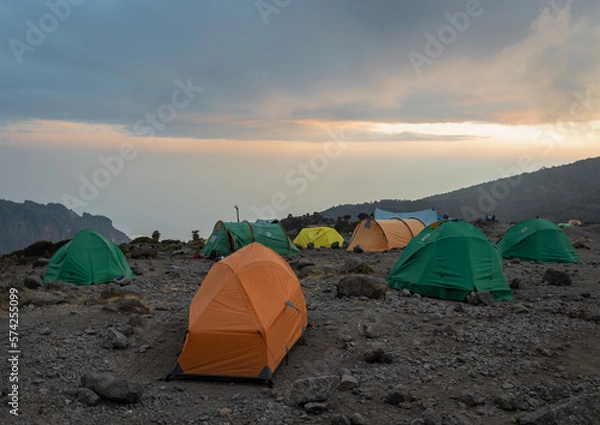 Fototapeta Camping in the Clouds - Tents on a Mountain Peak at Sunset