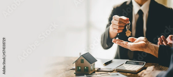 Obraz real estate agent Delivering keys and model homes to customers and home insurance contracts; home mortgage loan concepts