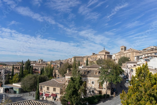 Obraz Panoramic view of one of the parts of the city of Toledo where we can find very nice stone houses on a summer day with partly clear sky. Spain