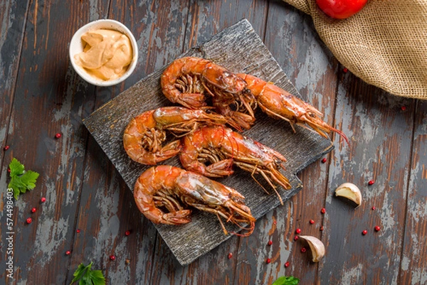 Obraz Fried langoustines on the Board on dark wooden table top view