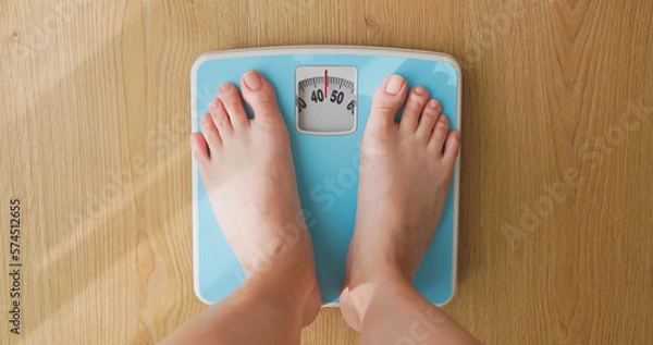 Obraz woman measure weight on scale