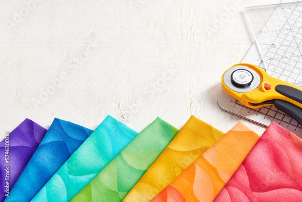 Fototapeta A set of fabrics for quilting in rainbow colors, quilting accessories, space for text