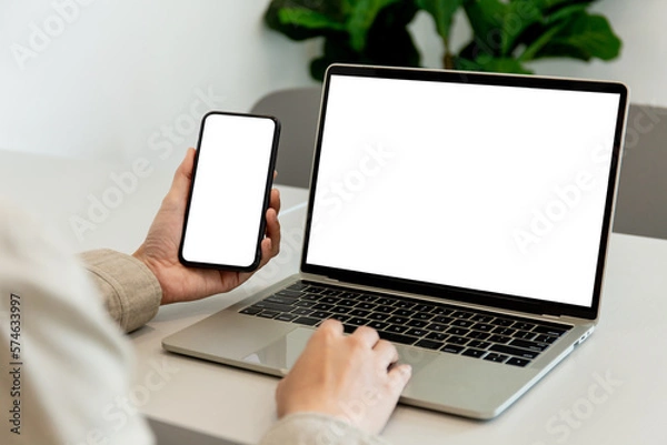 Fototapeta computer screen,cell phone blank mockup.hand woman work using laptop texting mobile.white background for advertising,contact business search information on desk in cafe.marketing,design