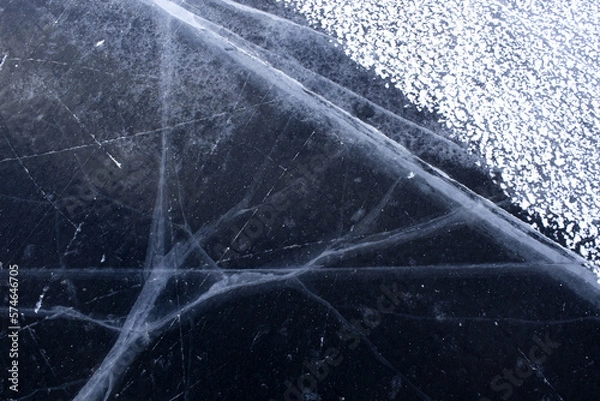 Obraz beautiful cracks in the ice. Volga in winter. Sunset on the winter river