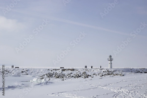 Obraz lighthouse on the coast in winter. Beautiful view on the mountains