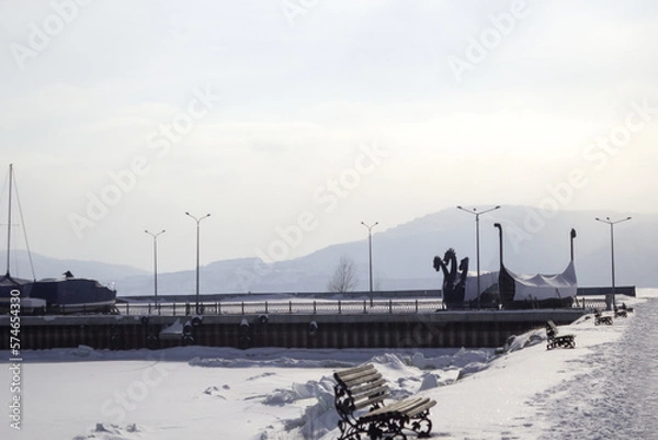 Obraz lighthouse on the coast in winter. Beautiful view on the mountains