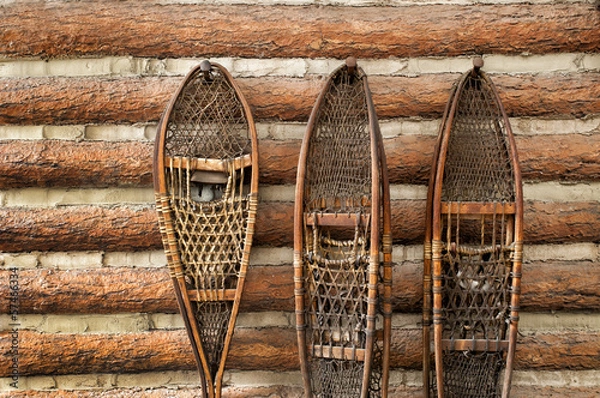 Obraz Snow shoes and a log cabin