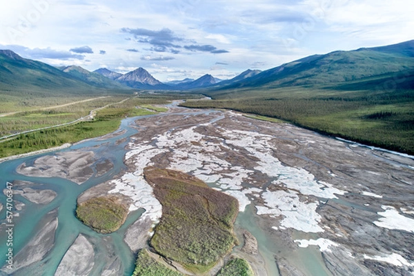 Fototapeta Aerial drone image of Fresh July Snow on the braided looking Dietrich River between the Coldfoot Camp and Prudhoe bay in Alaska with the Trans-Alaska Oil Pipeline
