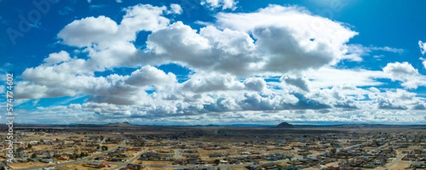 Obraz Puffy Clouds Blanket the Desert Cityscape in Ethereal Beauty