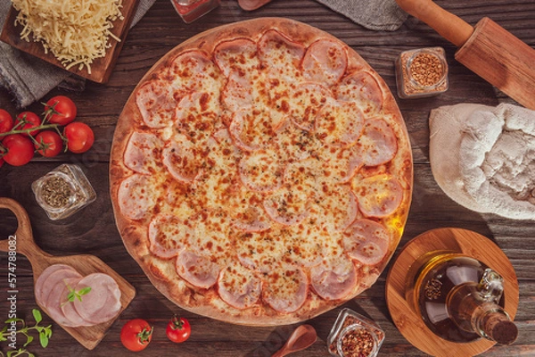 Fototapeta Brazilian pizza with mozzarella, pork loin and oregano (Pizza de lombinho) - Top view.