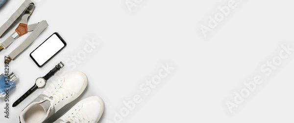Fototapeta Stylish man's look with suspenders and mobile phone on light background with space for text