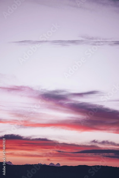 Obraz Soft pink, violet, and purple puffy clouds stretching upwards as if reaching for the heavens.