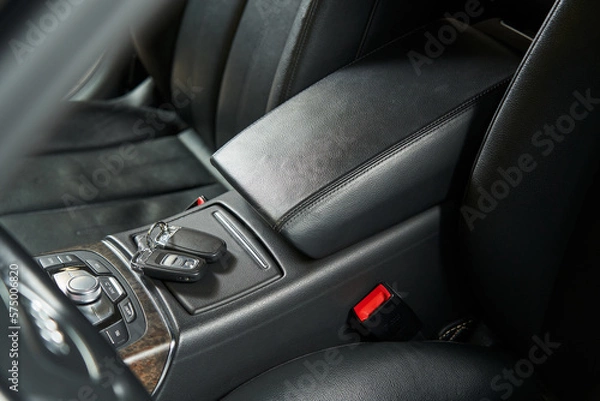 Fototapeta leather car armrest, keys lying on a hidden storage box