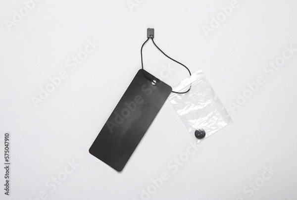 Fototapeta Black blank clothing price tag or label mockup with string on gray background. Sale, shopping concept