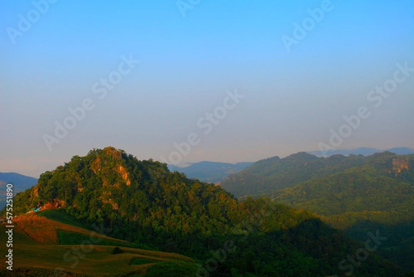 Obraz morning on the mountain sunrise there is a flower foreground