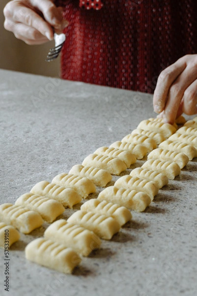 Fototapeta person preparing dough for gnocchi