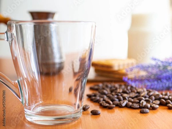 Fototapeta empty glass next to a pile of coffee beans, Cookies and milk bottle on background
