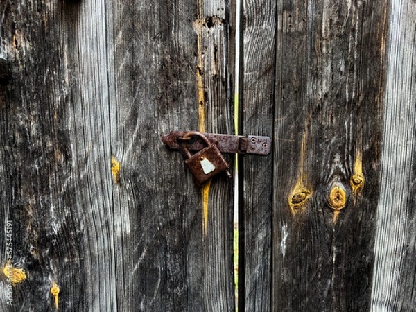 Obraz Capturing the nostalgia of an old wooden woor with an aged lock