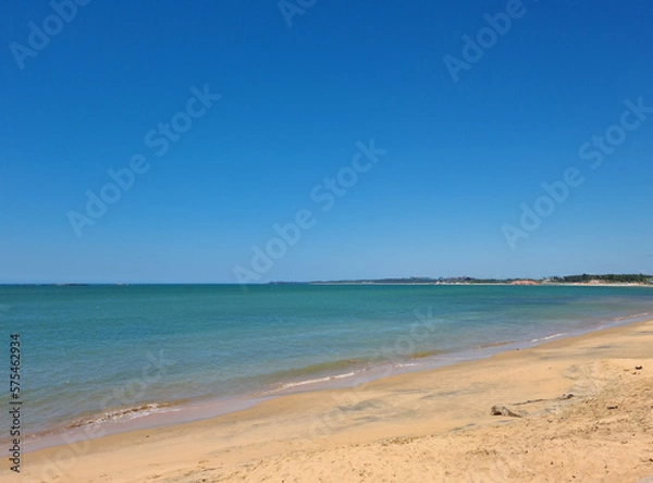Fototapeta Image by the beach with clear, smooth sand and dark blue sea